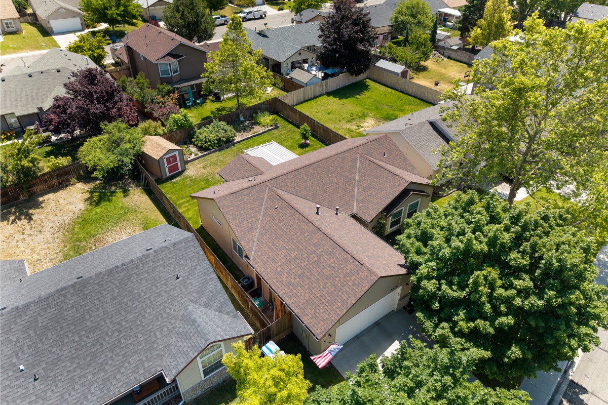 Overhead aerial view of a shingle roof and property
